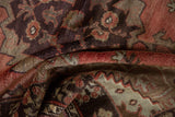 Folded pile detail of vintage Oushak rug, showing abrashed cinnabar, chocolate, and beige motifs.