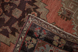 Folded Oushak runner corner shows secure edge, dark chocolate border, and cinnabar field.
