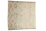 Distressed vintage Oushak square rug, geometric diamond pattern in soft cream, pink, blue.