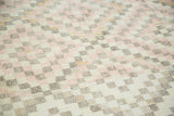 Distressed vintage Oushak rug, soft pink, cream, and taupe geometric diamonds.