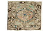 Vintage Oushak square rug: dusty blush field, teal diamond quatrefoil, hook patterns.