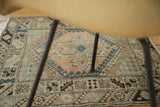 Detail of vintage Oushak rug border, with brown and faded teal hook motifs.