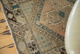 Fringed edge detail of vintage Turkish Oushak rug, plush blush, teal reciprocating hook pattern.