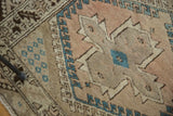 Plush Oushak rug pile showcases quatrefoil medallion, teal diamond, and hook motifs.