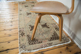 Distressed Oushak runner close-up, showing fringe, localized wear, and chocolate brown motifs.