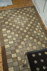 Distressed vintage Oushak runner with checkered design, stylized diamond, ivory, silver, and brown.