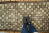 Distressed hand-knotted Oushak runner; geometric checkered pattern in ivory and brown tones.