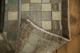 Vintage Oushak runner featuring distressed checkered pattern, hand-knotted foundation, and fringe.