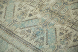 Intricate Seychour Kuba geometric pattern with distressed texture in soft copper green and sand.