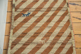 Blue animal motif on plush ivory and bronze diagonal striped Gabbeh rug.