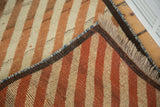 Hand-knotted foundation, fringed end, and thick striped pile of a vintage Gabbeh runner.