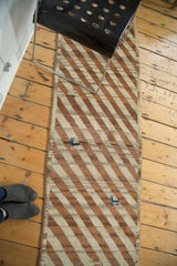 Diagonal stripes, blue animal motif, and woven side selvedge of the vintage Gabbeh runner.