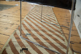 Plush Gabbeh runner pile shows diagonal ivory, bronze stripes and small teal animal motifs.