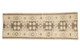 Hand-knotted Vintage Oushak runner displays geometric multi-medallion starburst patterns in sand and brown. 2'9