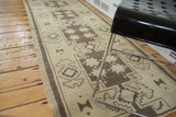 Vintage Oushak runner, hand knotted, showcasing tribal geometric starbursts in sand and brown.
