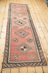 Vintage Turkish Oushak runner, faded cinnabar field, repeating geometric pinwheel motifs.