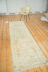 Oushak runner detail, showing faded sand medallion and sea foam starburst design.