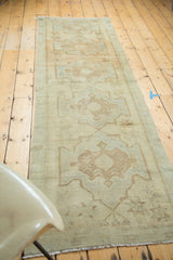Vintage Oushak runner with faded sand field, seafoam medallion, starburst pattern, and fringe.