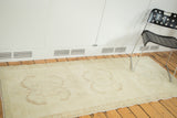 Subtle inverted samovar design elements on vintage Oushak rug in faded bronze, ivory.