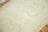 Ivory hand-knotted Oushak runner with faded bronze inverted samovar design elements.