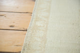 Secured side of a vintage Oushak rug, showcasing subtle ivory motifs and hand-knotted texture.