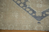 Distressed sand and beige pile with dusty blue pattern and fringe.
