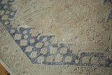 Distressed texture of a hand knotted vintage Oushak rug with sand and dusty blue tones.