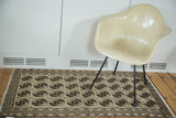 Vintage Konya runner featuring brown elephant footprint pattern and checkered border.