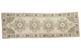 Distressed hand-knotted Oushak runner, beige field with quadruple medallions and brown, silver arabesques.