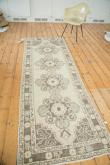 Vintage Oushak runner corner with beige field, chocolate brown, silver expressive arabesques.