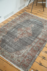 Textured distressed chocolate brown field with faded brick red quatrefoil medallion details.