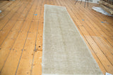 Distressed vintage Oushak runner, highlighting analogous sand and beige texture.