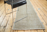 Distressed sand beige Oushak runner with visible textured pile and short fringe.