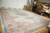 Subtle sky blue and peachy blush tones on a distressed vintage Oushak carpet.