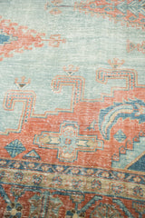 Distressed pile texture of vintage Oushak carpet with sky blue and peachy blush motifs.