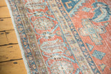 Distressed aesthetic of Vintage Oushak rug with sky blue, peachy blush motifs.