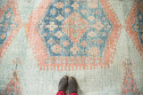 Distressed texture of vintage Oushak rug with sky blue and peachy blush.