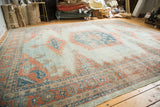 Distressed hand-knotted Oushak corner, soft sky blue and peachy-blush patterns.
