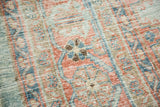 Distressed pile of vintage Oushak rug with sky blue and peachy blush motifs.