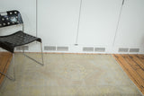Faded octagonal medallion of distressed Oushak rug in soft saffron and ivory.