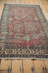 Distressed cherry red Oushak rug field with sprawling palmettes and exposed foundation.