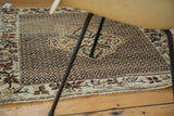 Intricate grape leaf vinery border and secured end of the vintage Oushak rug.