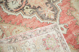 Distressed vintage Oushak rug pile with cinnabar red tones and hand-knotted foundation.
