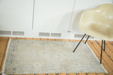 Distressed vintage Oushak rug with textured pile and faded medallion in sand and slate blue.