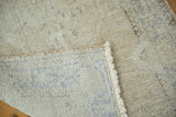 Reverse side of a vintage Oushak rug, revealing blue hand-knotted foundation and natural ivory fringe.
