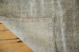 Hand-knotted foundation, secured side, and distressed earth-tone pile of a Vintage Oushak rug.