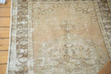 Distressed vintage Oushak rug surface, showing faded motifs and exposed foundation.