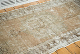 Decorative distressed texture of a vintage Oushak runner with visible foundation in faded beige and copper.