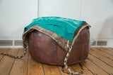 Hand loomed vintage grain bag in natural ivory, grey, and brown tones with braided ties.