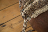 Coarse, speckled Moroccan grainbag weave in ivory, grey, brown goat hair, with twisted tie.